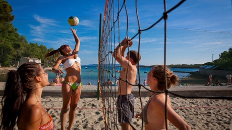 Beach volleyball game with a group of people