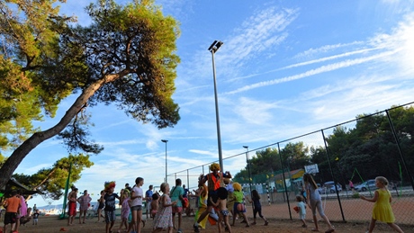 Children playing outdoors at a park under a clear blue sky