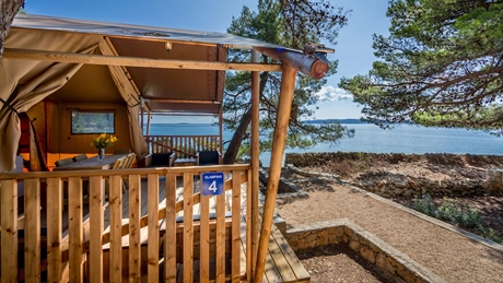 A glamping tent with a wooden deck overlooking the sea on Cres or Losinj