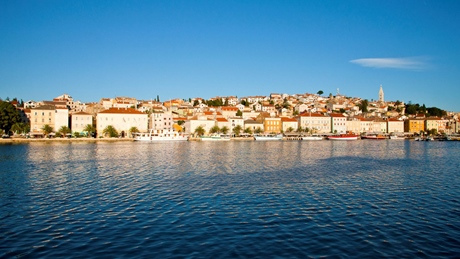 Scenic view of Mali Losinj waterfront with colorful buildings and clear blue sky