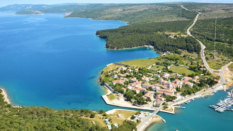 Aerial view of a coastal village by a blue bay