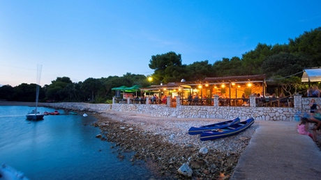 Waterfront restaurant in a scenic coastal setting at sunset
