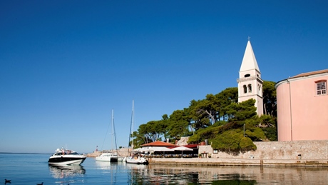 Losinj waterfront with boats and a church tower