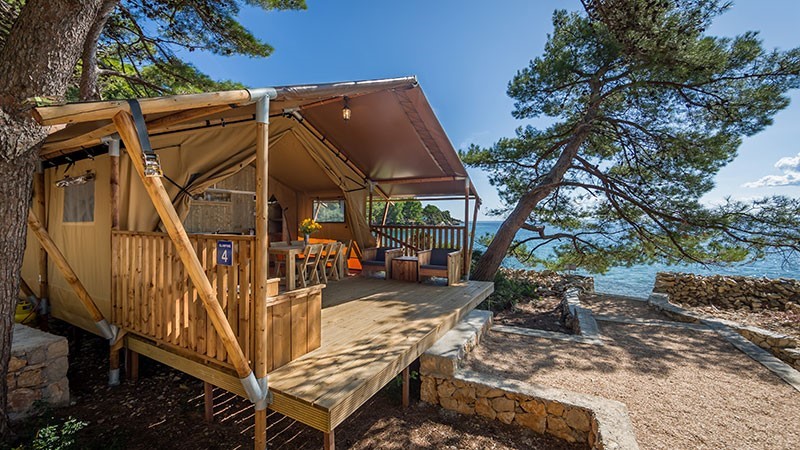 Cozy tent setup with a wooden deck at Baldarin by the sea