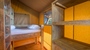 Interior of a glamping tent with wooden bunk beds at Baldarin